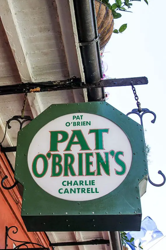 Hanging sign in green and white that reads Pat O'Brien's