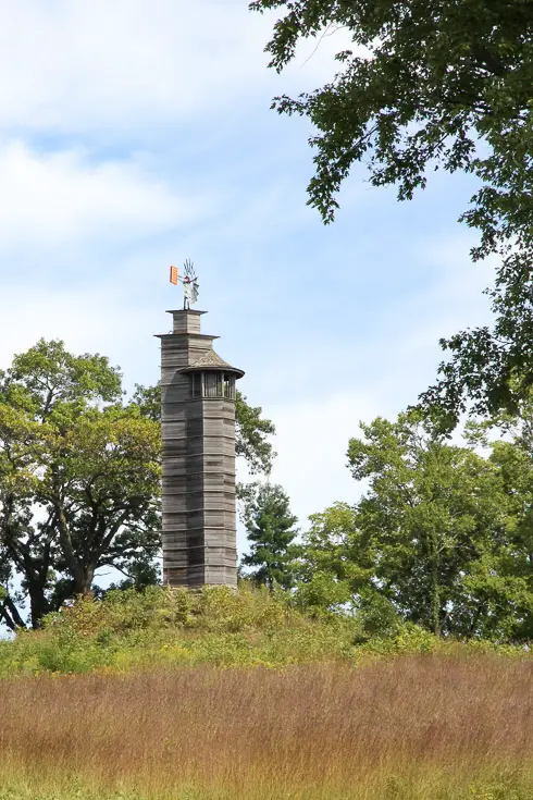 Grey windmill on hill