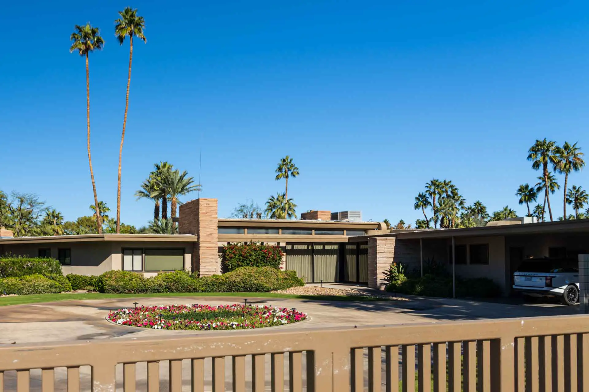 Exterior of Mid-Century Modern home with two tall palms