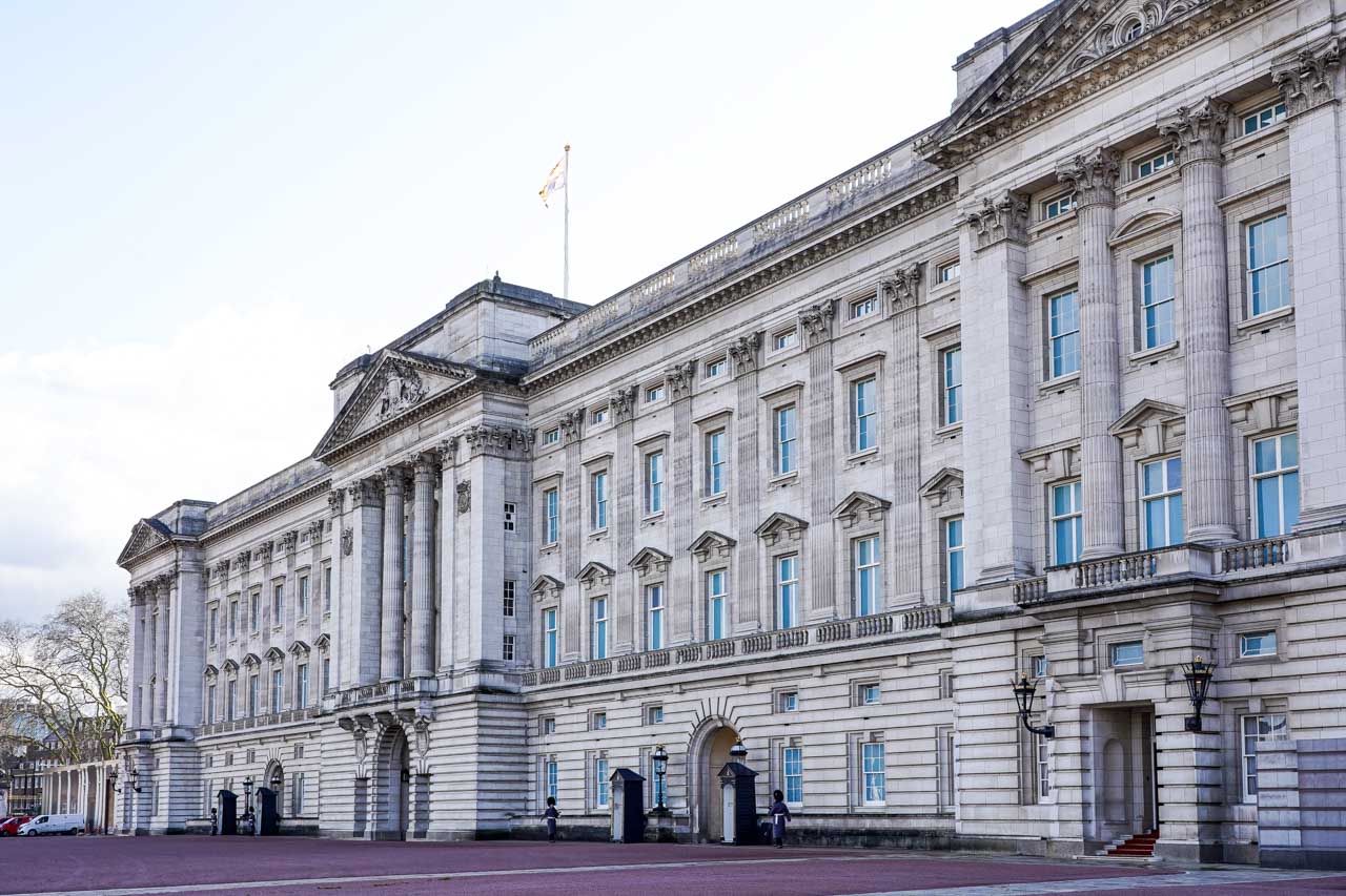 Exterior of Buckingham Palace with marching guards