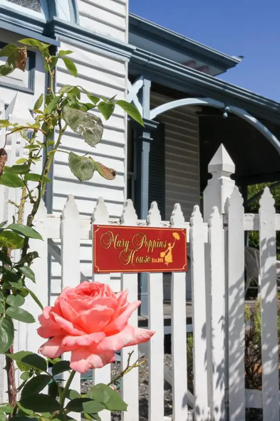The rose framed, front gate and white picket fence of Mary Poppins House
