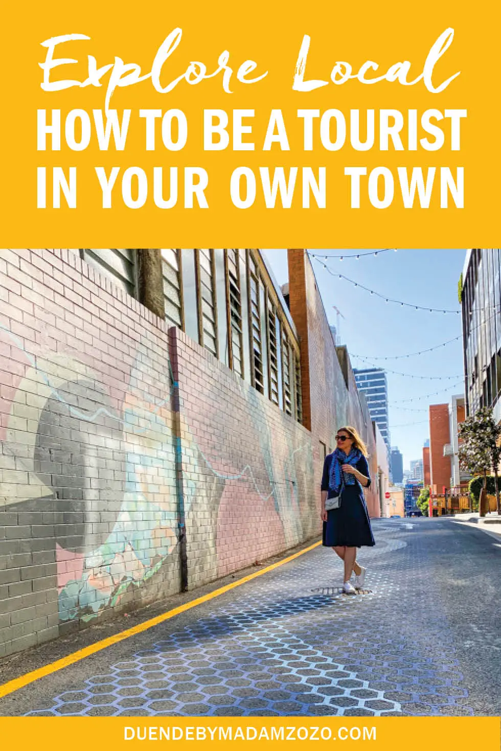Image of woman standing in alleyway with street art and text overlay reading "Explore Local - How to be a Tourist in Your Own Town"
