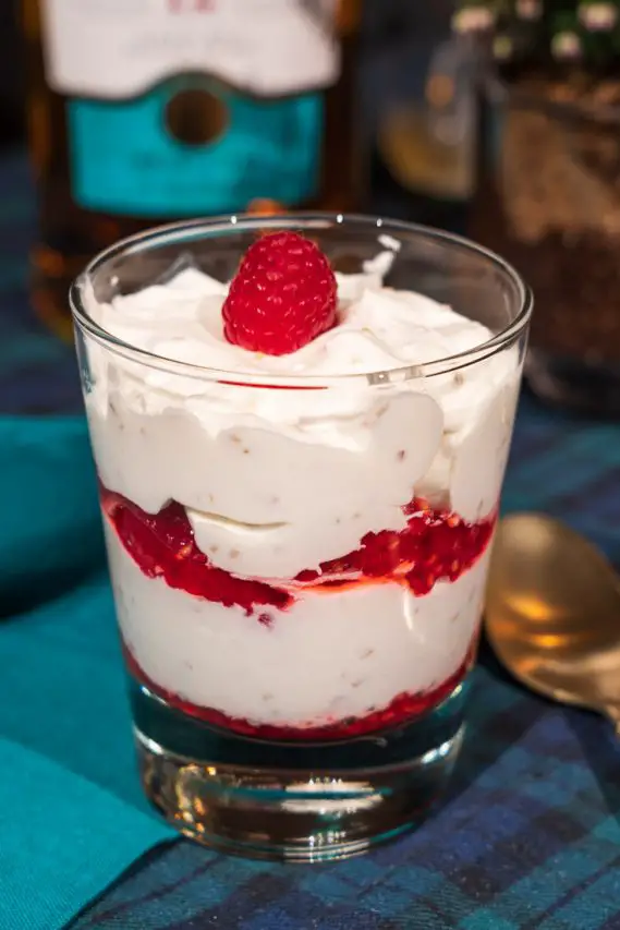 Layered dessert in a glass - raspberries and cream