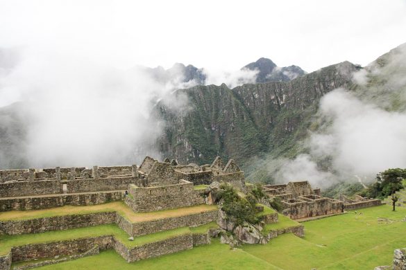 Mist shrowded archaeological site with mountains in the background