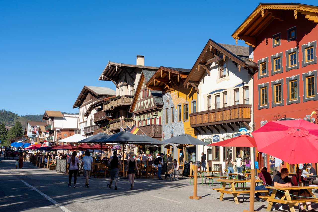 Bavarian streetscape with dining tables and umbrellas in the street