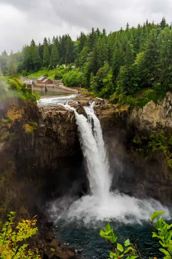 Photo of waterfall with forest in background