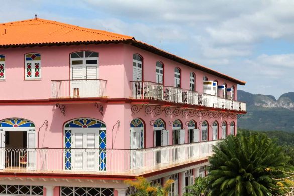 Pink Spanish colonial building with balconies and arched doorways