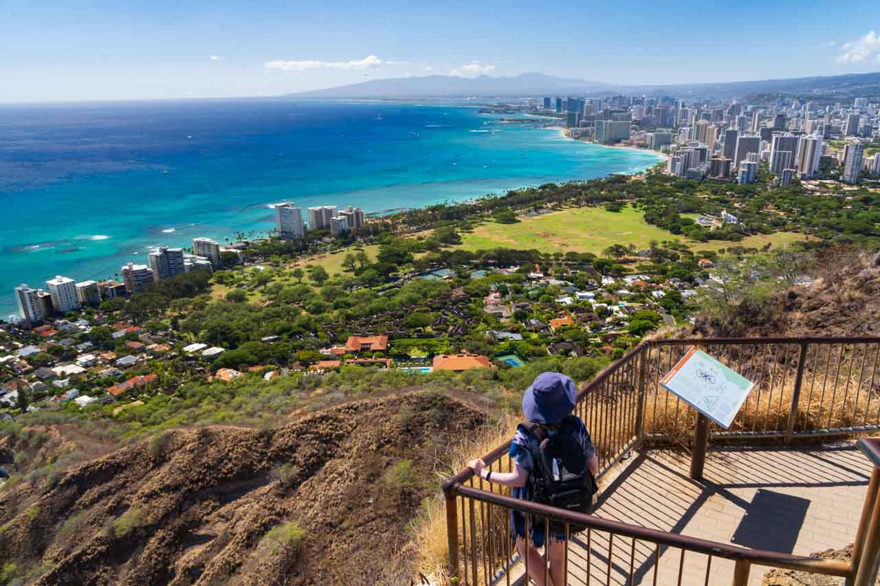 Woman looking down over Waikiki Beach from Diamond Head trail summit