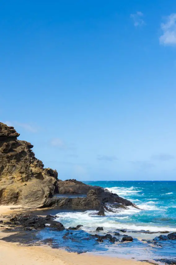 Photo of rocky headland giving way to sandy beach