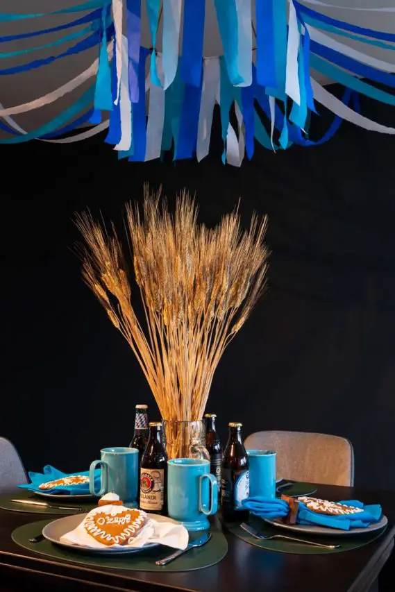 Oktoberfest table setting with lebkuchenherzen on placesettings and wheat in beer mug centrepiece