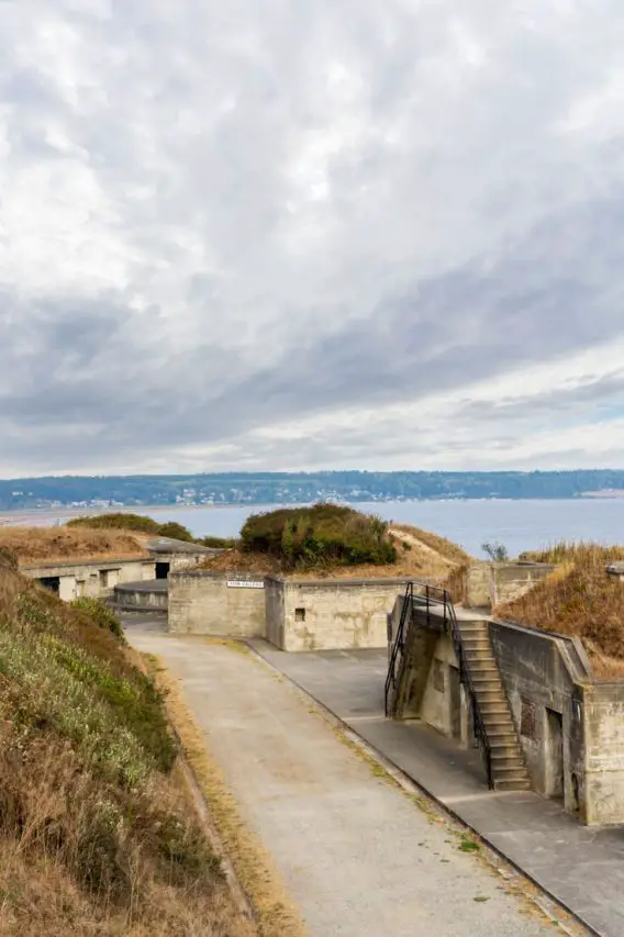 Concrete fortifications of a military fort near the water with grey clouds