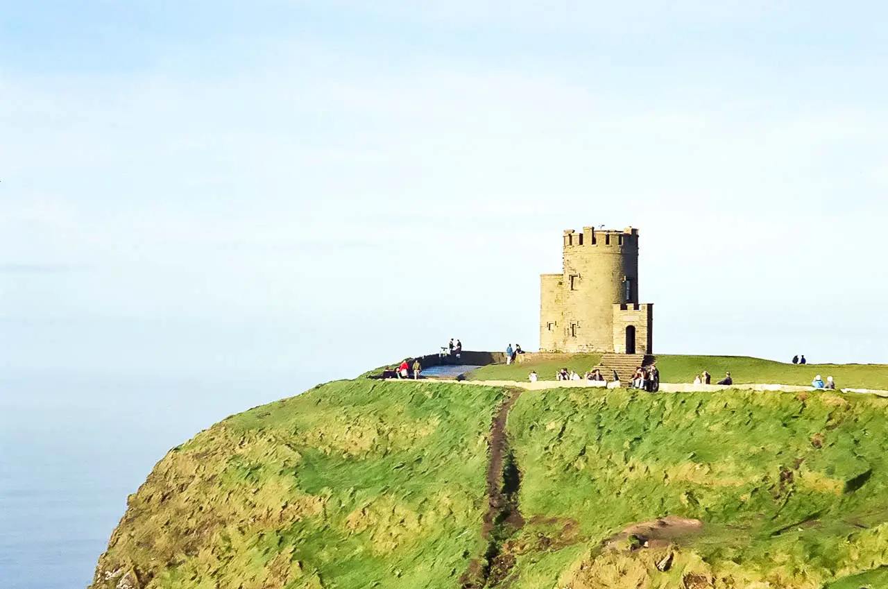 Historic stone building on sunkissed Cliffs of Moher