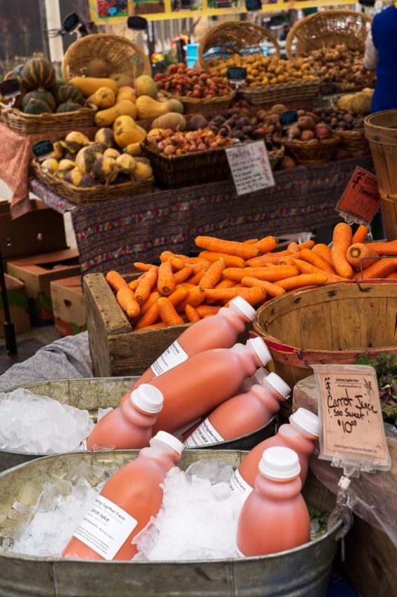 Fresh produce and carrot juice for sale at farmers market