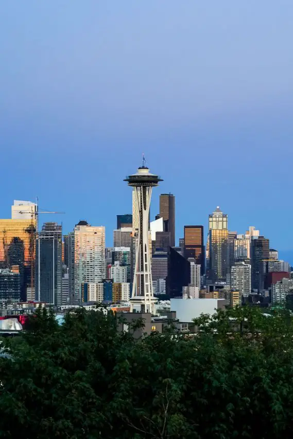 View of Seattle cityscape at twilight with blue sky and golden light on buildings