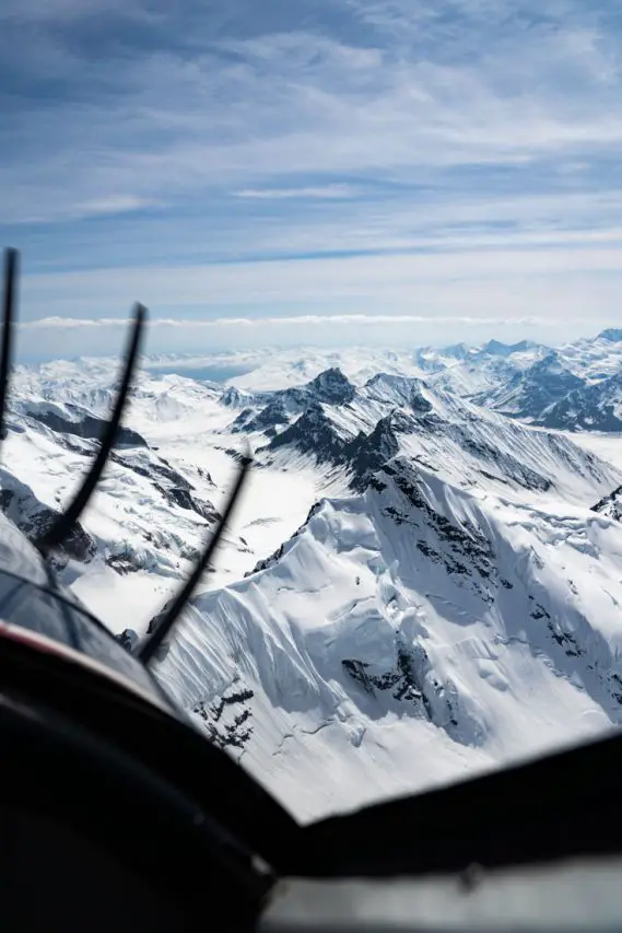 Photo of mountains with plane propellor in foreground