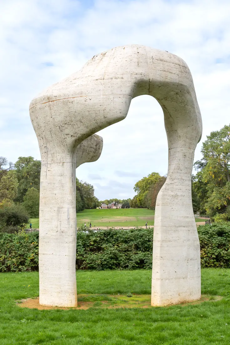 Modern sculpture in greenspace, framing distant view of Kensington Palace