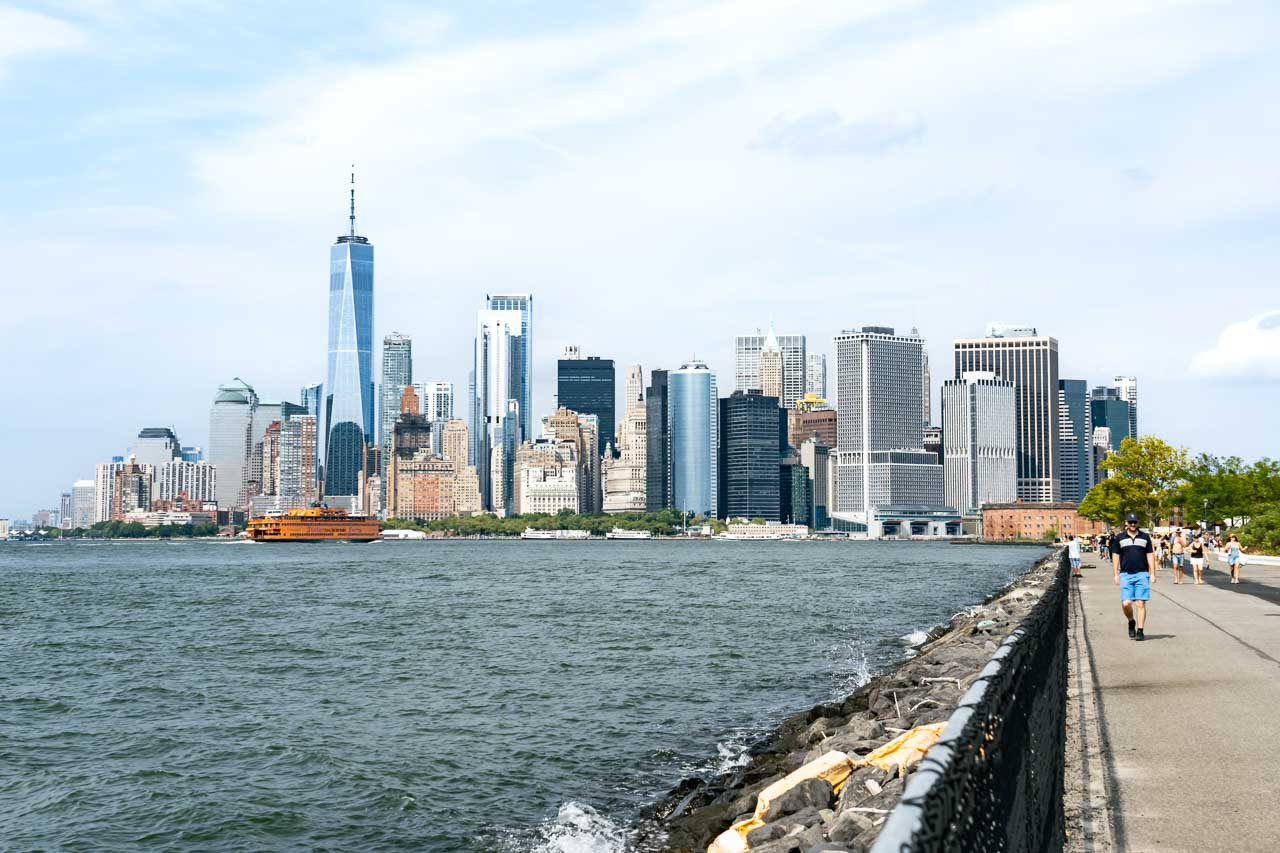 Governor's Island view back at Manhattan with man walking in foreground