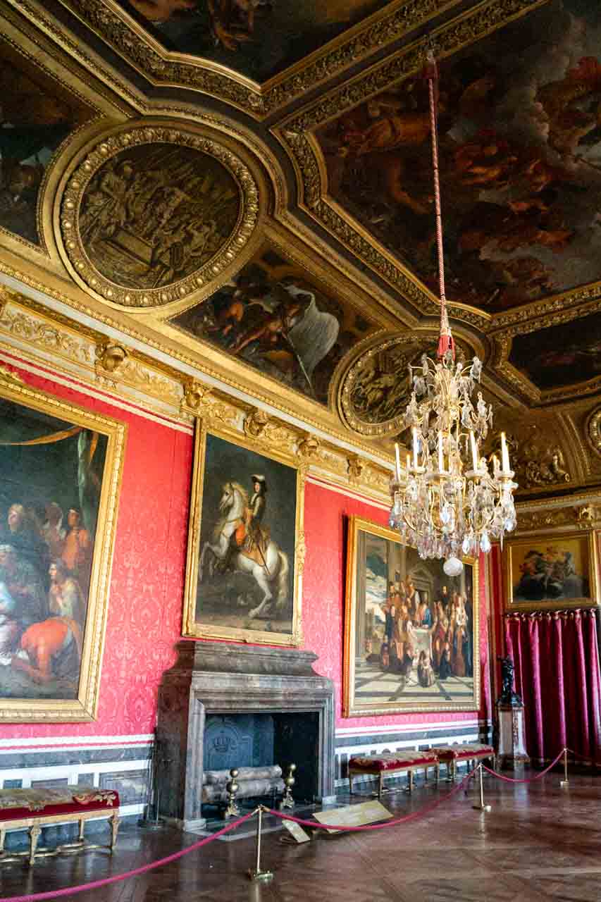 Red room with fireplace and murals on ceiling