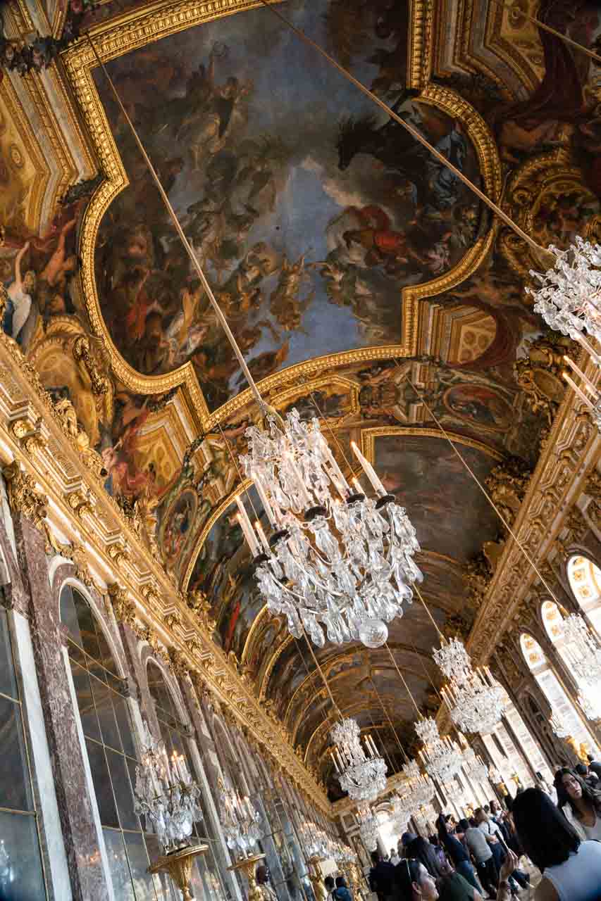 Long Room with vaulted ceilings covered in gold leaf and murals with many crystal chandeliers