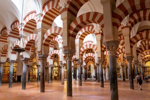 Rows of double arches and columns, with red and white striped paint